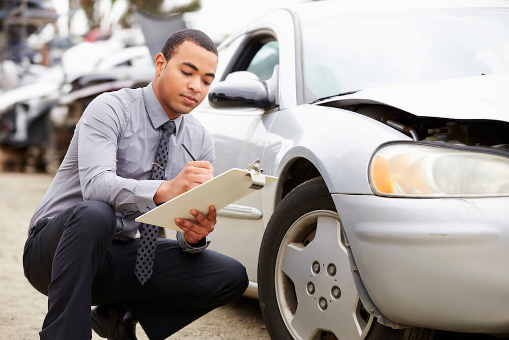 Loss Adjuster Inspecting Car Involved In Accident - Check your brakes before a summer road trip