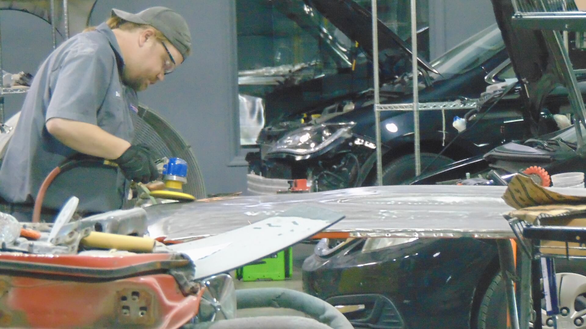 body shop technician repairing an auto body - Fender Mender